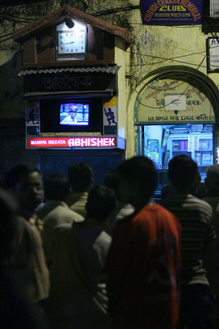 Fans watch the game on the television in a street corner, Kolkata, April 19, 2007