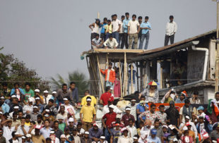 Fans watch from an under-construction building adjoining the stadium, India v Australia, 6th ODI, Guwahati, November 8, 2009