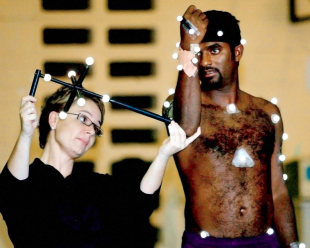 Muttiah Muralitharan is measured by a biomechanics researcher during a series of tests on his action at the University of Western Australia, Perth, April 1, 2004