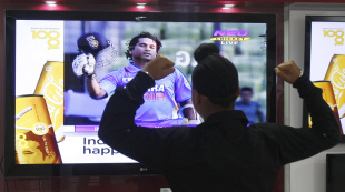 A young fan celebrates after watching Sachin Tendulkar get his 100th international hundred, Delhi, March 16, 2012
